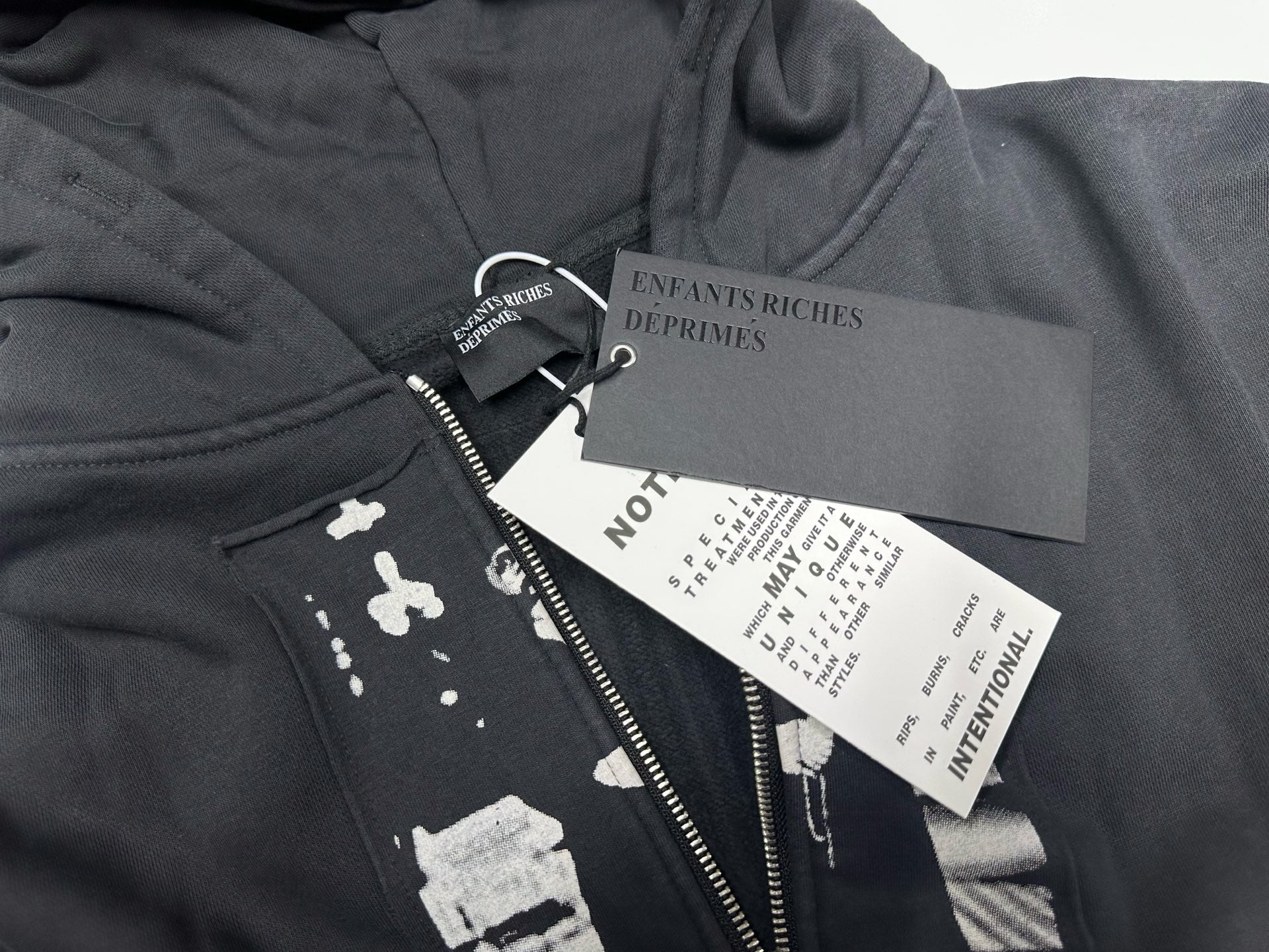 ER* Artist Defends Washed Black Zip Hoodie™