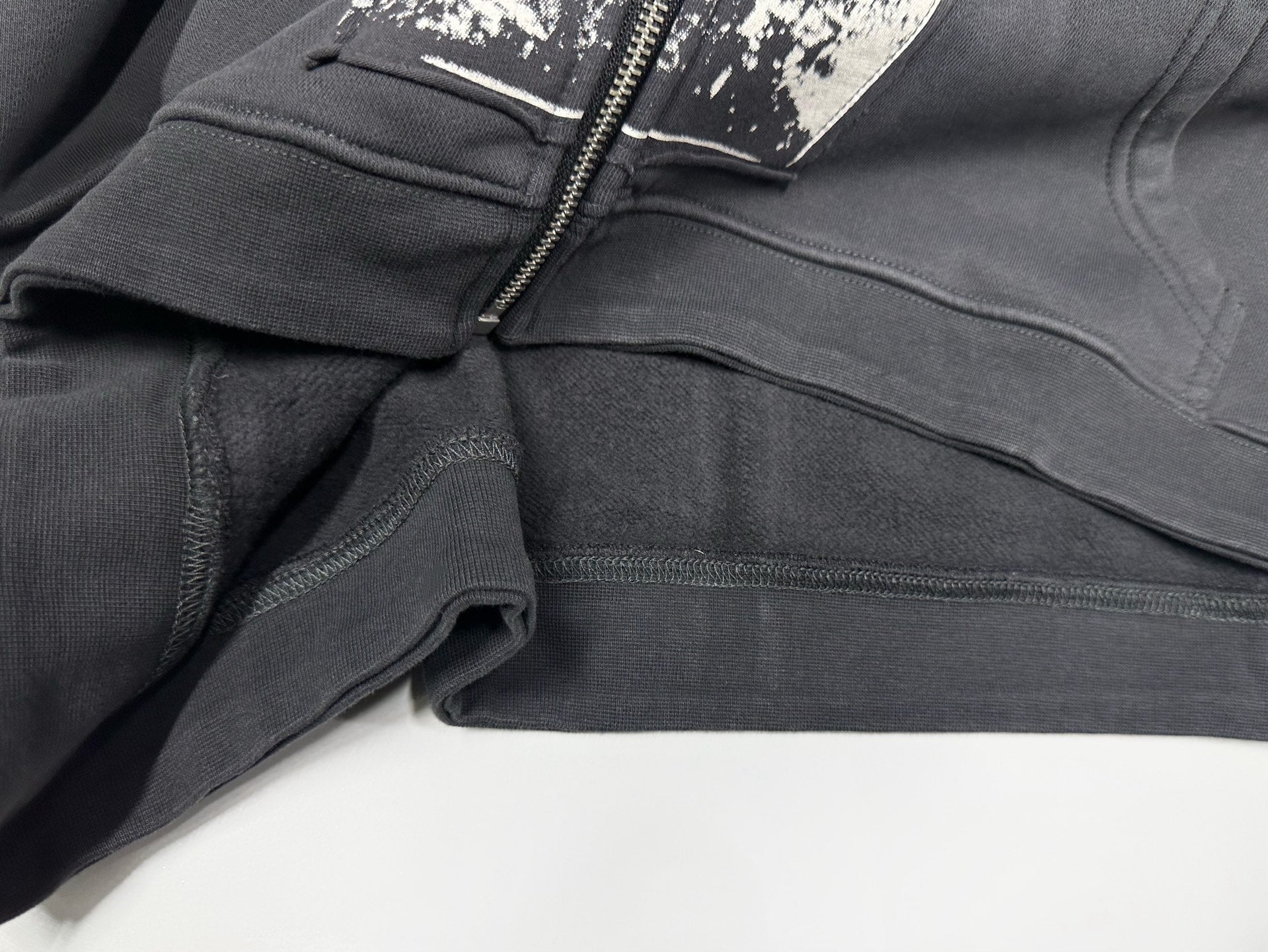 ER* Artist Defends Washed Black Zip Hoodie™