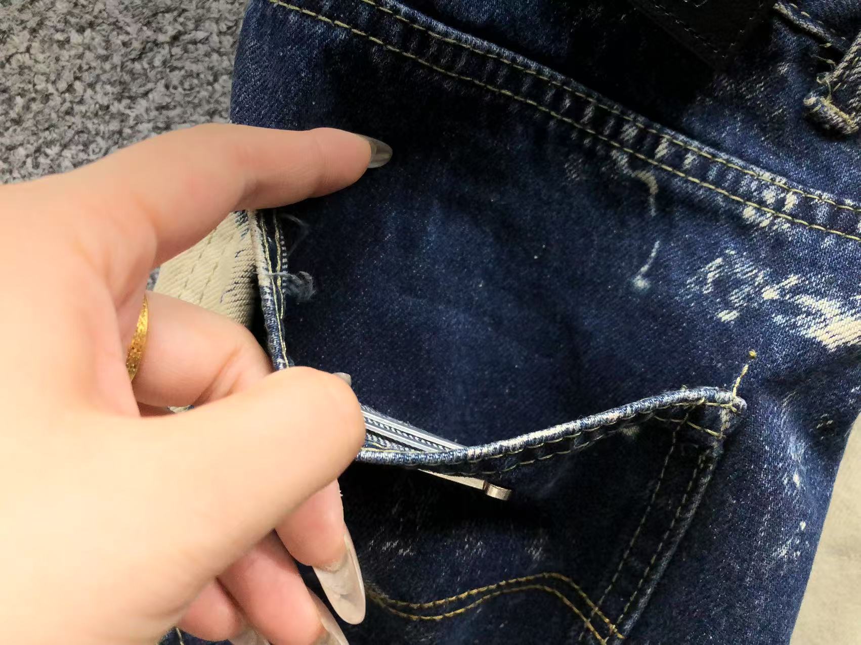 White Brown & Orange Cross Patch White Paint Marks Dark Blue Denim Jeans™