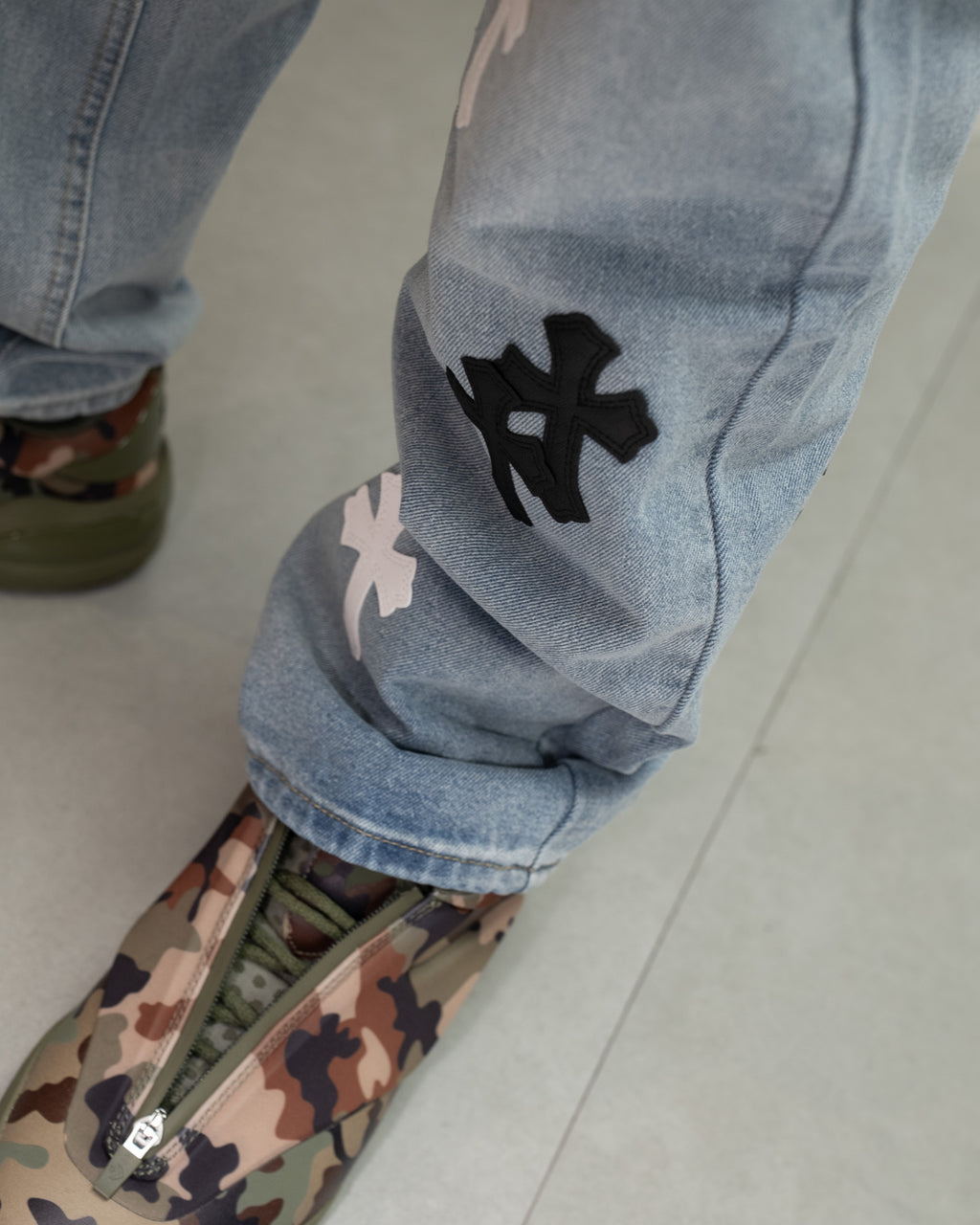 White & Black Cross Patch Light Denim Jeans™